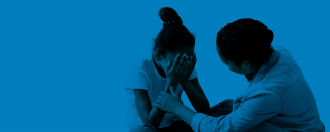 Woman comforting sad teenage girl