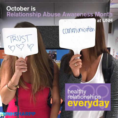 2 students holding signs that say "trust" and "communication"