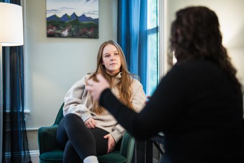 Picture of an advocate talking with a client in a room