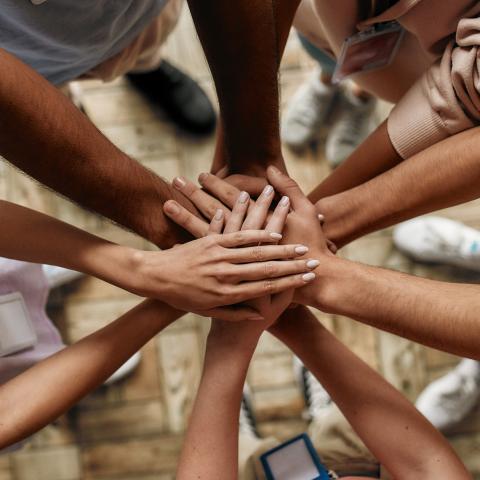 Picture of a group of hands put together in a communal fashion