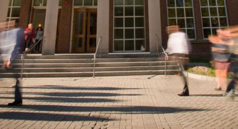 UNH students walking in front of building