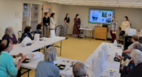 people around table in masks