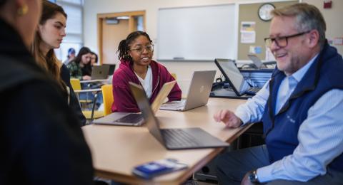 Professor Robert McGrath working with students in the United State Health Care Systems course