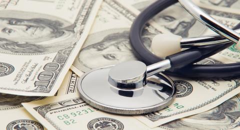 stethoscope resting on money