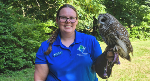 Kaylee Finch smiling holding an owl