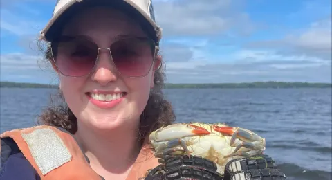 Caylin smiling holding a crab