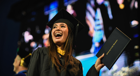 GCHS Alum Kristy Miyashita holder her diploma at graduation