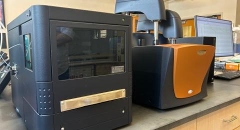 A black electrical box sits on a desk