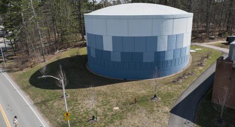 Aerial view of UNH's Thermal Energy Storage Tank, a blue and white cylindrical structure