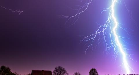 Stock photo of a lightning bolt behind a house
