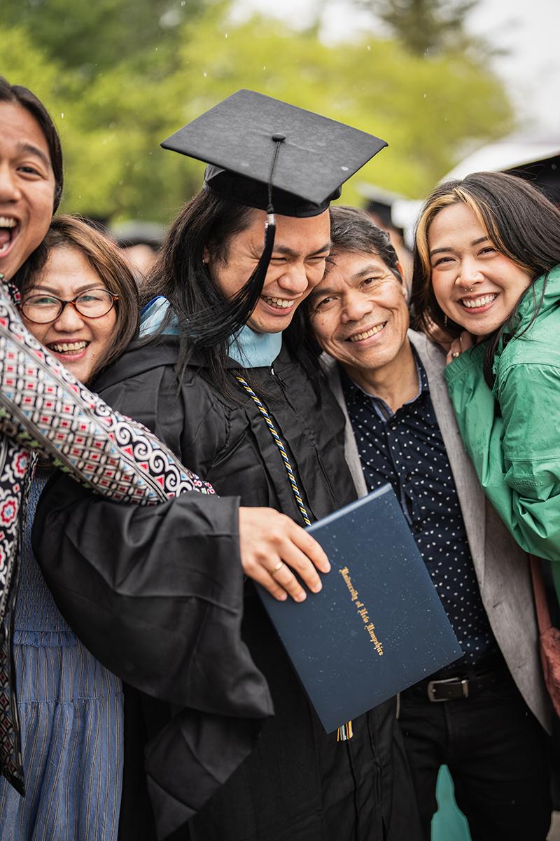 A family crowds together after commencement