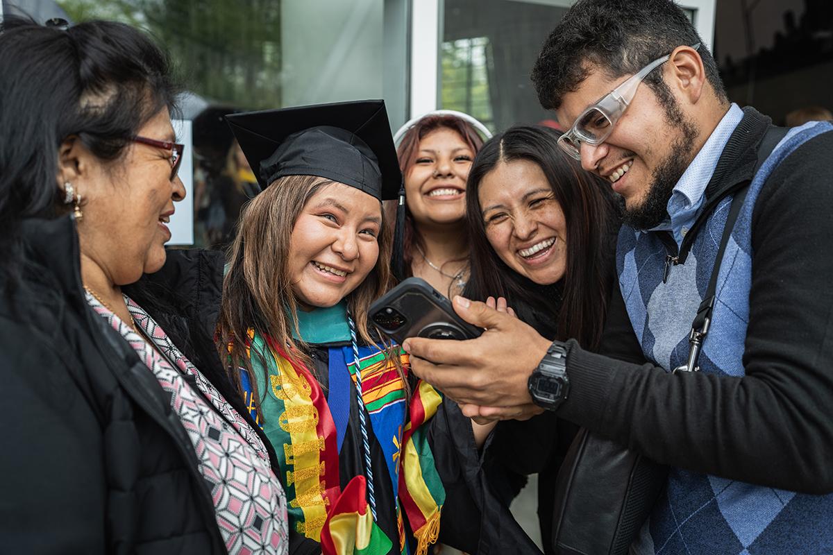 A family gathers outside after commencement