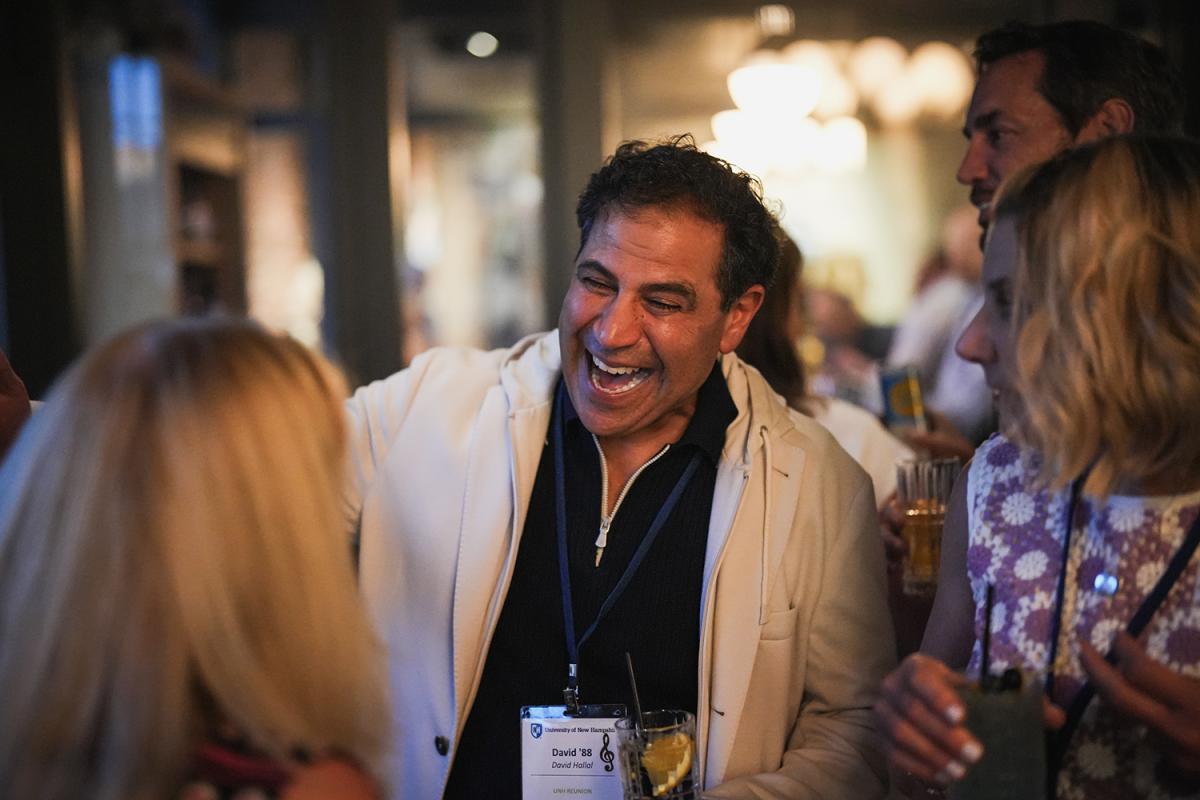 A man laughs while chatting during reunion