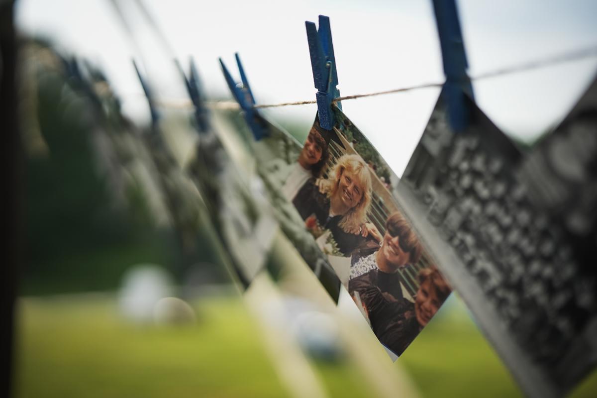 Photos hanging from clothespins on a clothesline
