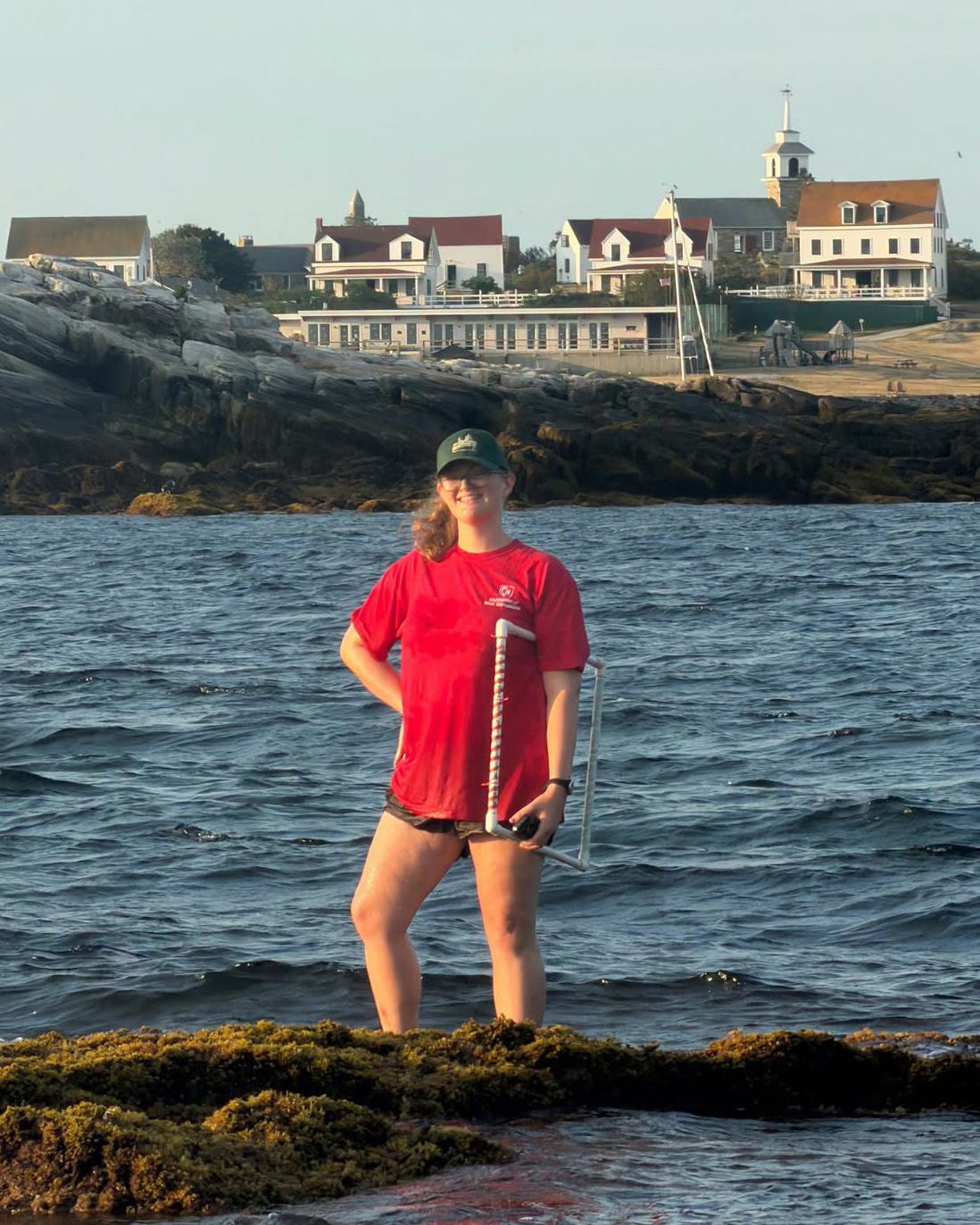 Melanie Carolan along the shore in front of the ocean
