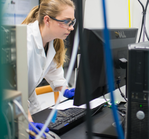 UNH student using a computer in a science lab