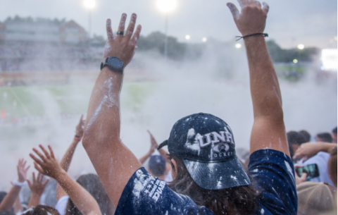 UNH fans watching football game