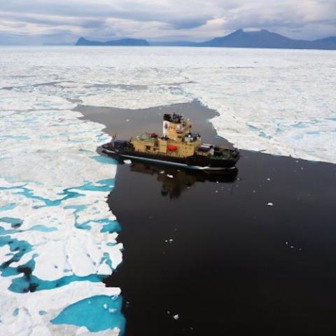 Drone shot of icebreaker ship in frozen Arctic sea