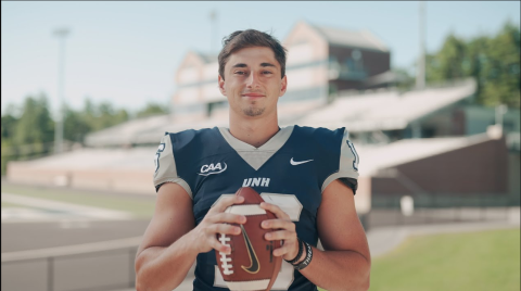 Max Brosmer holding football