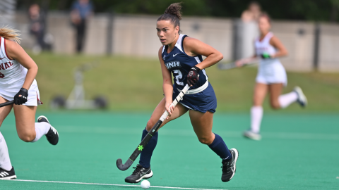 UNH student playing field hockey