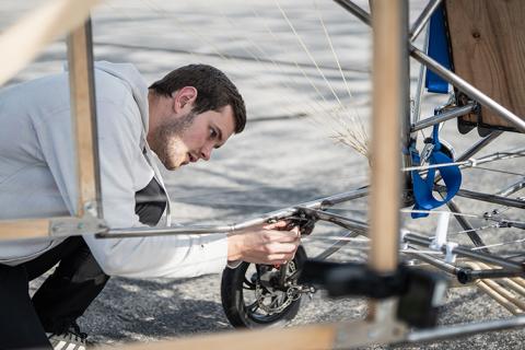 Marcus Herold ’25 works on the ultralight aircraft ahead of the first test flight.