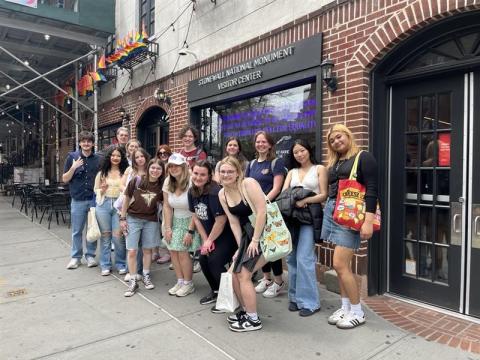 Group standing in front of Stonewall National Monument in NYC