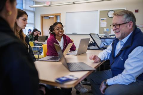 Professor Robert McGrath working with students in the United State Health Care Systems course