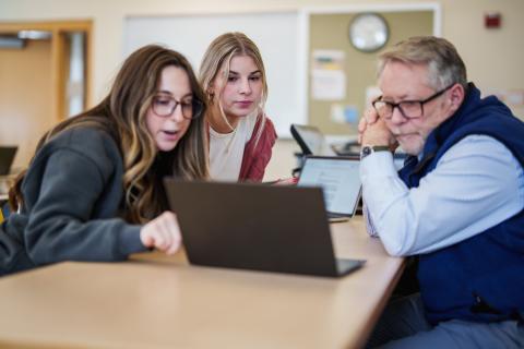 Professor Robert McGrath working with students in the United State Health Care Systems course