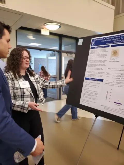 UNH genomics major Caylin Grove presenting her work at the UNH Undergraduate Research Conference