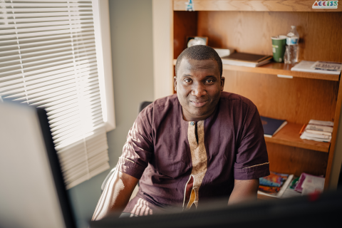 MCD alumni Jean Hakuzimana at his desk