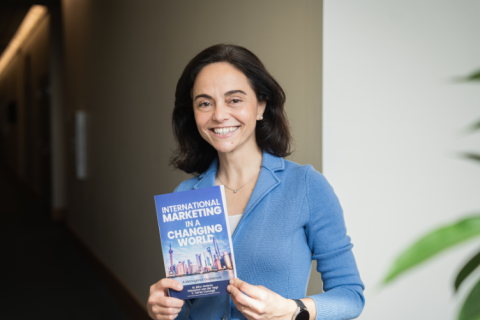 Billur Akdeniz poses at Paul College with her new book “International Marketing in a Changing World: A Managerial Guidebook.”