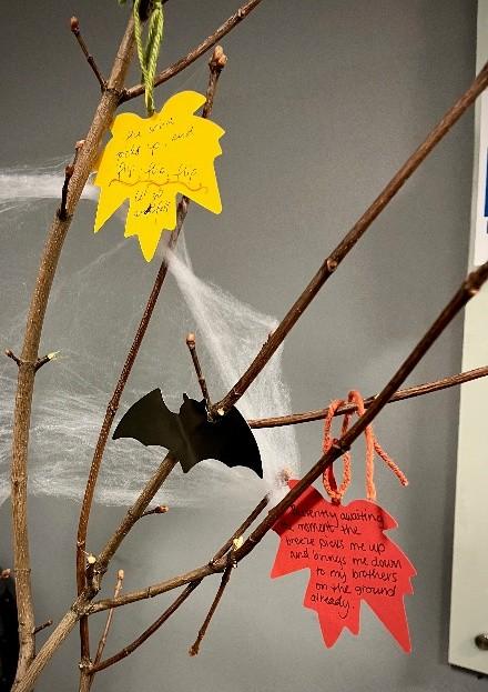 cut out leaves hung on branches of a tree