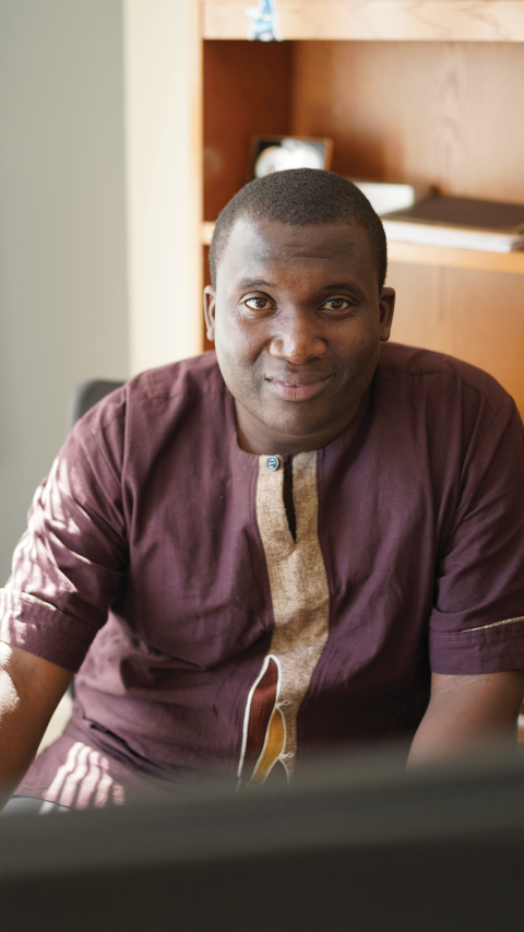 MCD alumni sitting at his computer