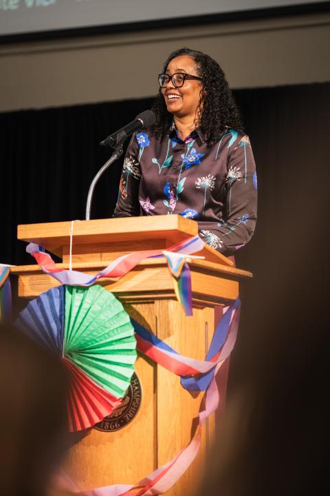 Nadine Petty speaks at a podium during the Pride and Pancakes breakfast