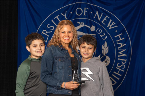 Rebecca Sanchez and two sons accepting her Award