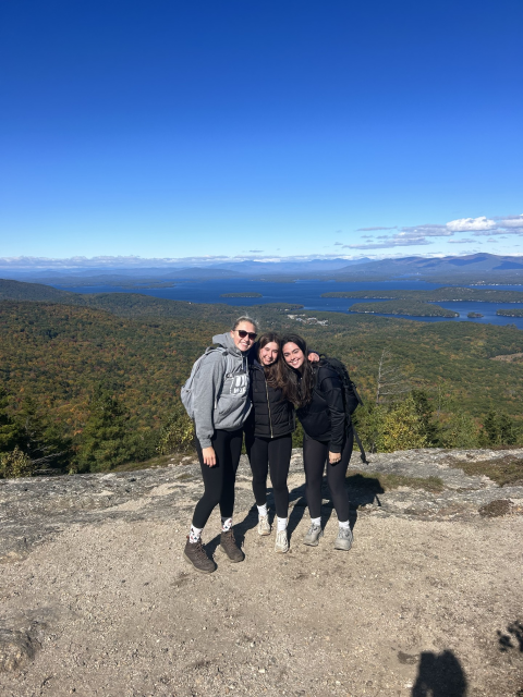 three people hiking in the mountains