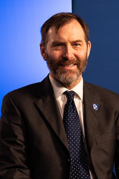 Dr. Andrew McPherson with blue background