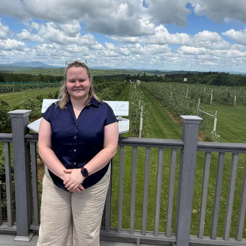 person standing outside with fields in the background