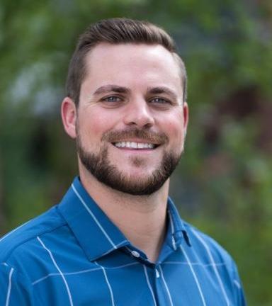 Headshot of male with beard wearing blue shirt
