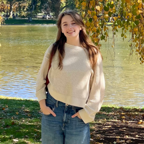 person standing outside with a body of water in the background