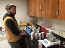 Karam Sheban as a graduate student at Yale University, working in the soil analysis lab. Photo source: NESARE. Credit: NESARE/Karam Sheban. More info: Importance of Environmental Factors on Plantings of Wild-Simulated American Ginseng (2021).