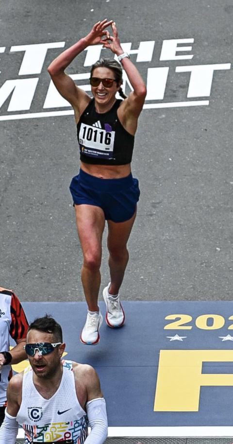 Kristina Robb crosses the finish line at the Boston Marathon.