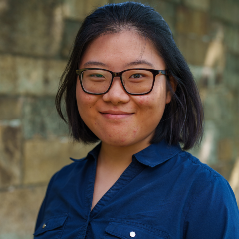 Aizhe smiling wearing glasses