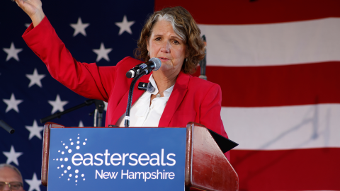 MCD alum and Easterseals NH & VT CEO Maureen Beauregard at a podium with her hand in the air
