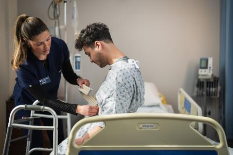 A UNH occupational therapy student works with a patient.