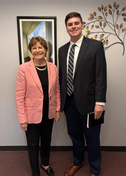 Ben Goguen ’27 stands with U.S. Sen. Jeanne Shaheen during his summer internship.