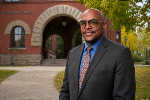 Photo of Ken Holmes infront of Thompson Hall