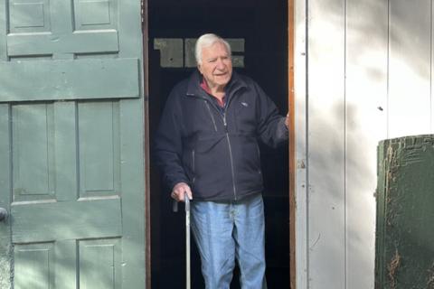 Mel Rines stands in a doorway