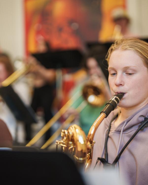 UNH student playing saxophone