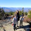 Three young hikers pose on a mountain top